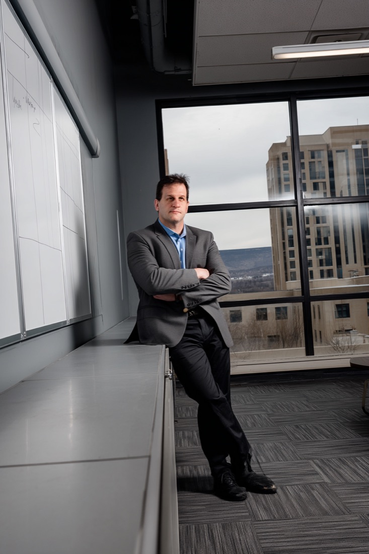 Matthias Pupillo, arms crossed, standing in the Auxiliary Digital office